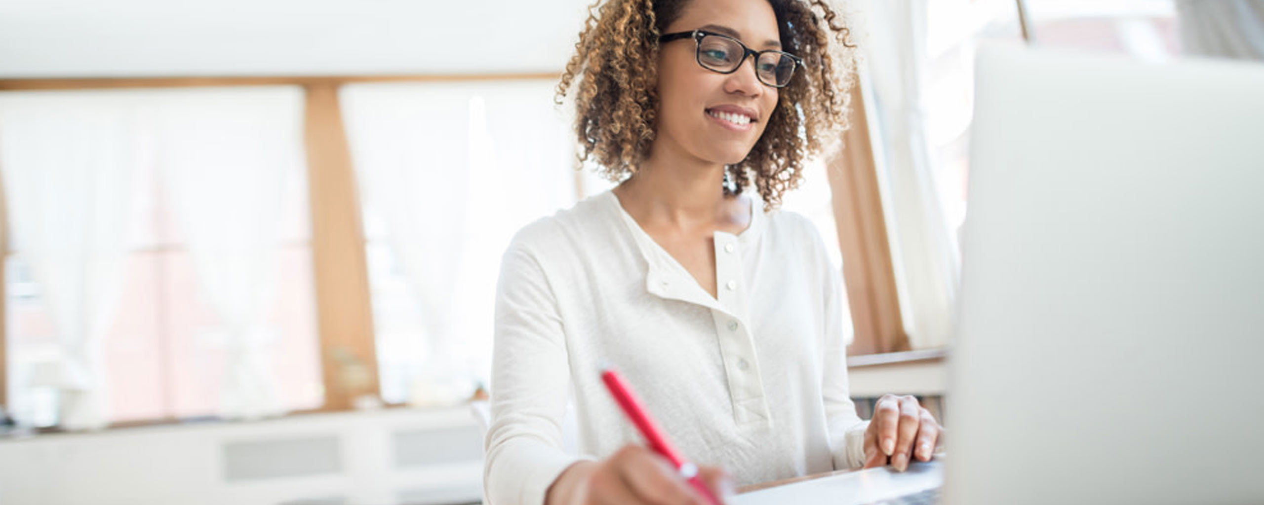 A woman uses her free time to find freelance opportunities to support her small business.